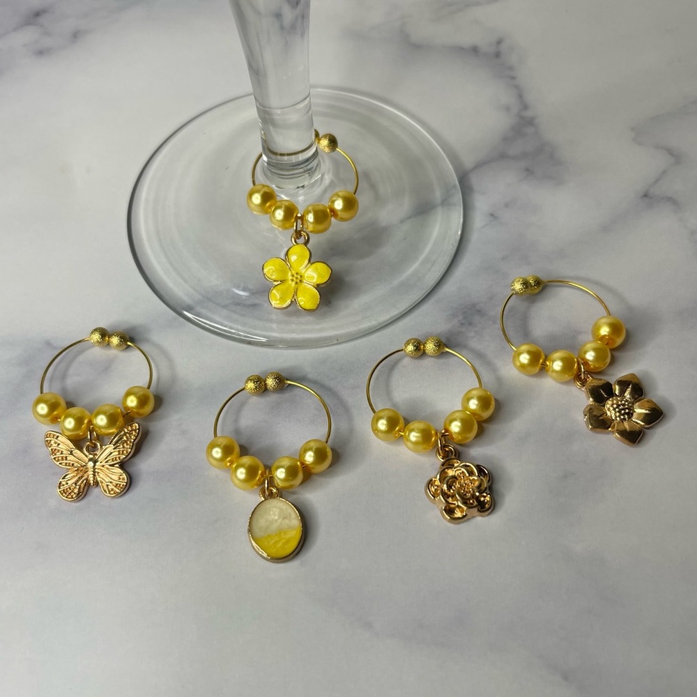 5 yellow and gold wine charms